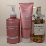 Hydrating haircare products for a sensitive scalp — Kundal Protein Bonding Shampoo, &honey Deep Moist Shampoo arranged on a neutral background.