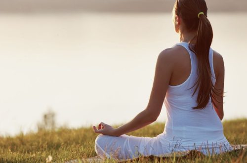 woman practicing yoga outdoors at sunrise — supporting hormonal balance in autumn