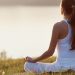 woman practicing yoga outdoors at sunrise — supporting hormonal balance in autumn